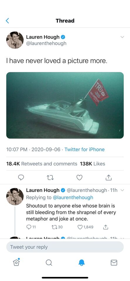 a close up of a cell phone with a picture of a boat