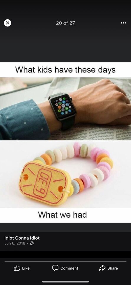a close up of a person holding a smart phone with a bracelet on it
