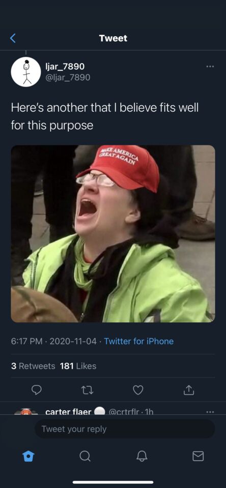 a close up of a person wearing a red hat and green jacket