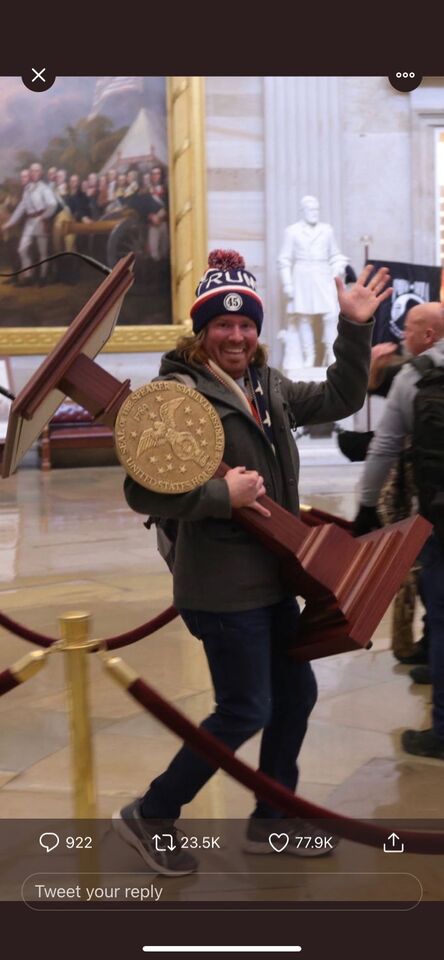 there is a man holding a large wooden object in a building